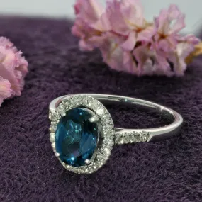 9ct White Gold Oval Blue Topaz & Diamond Halo Ring